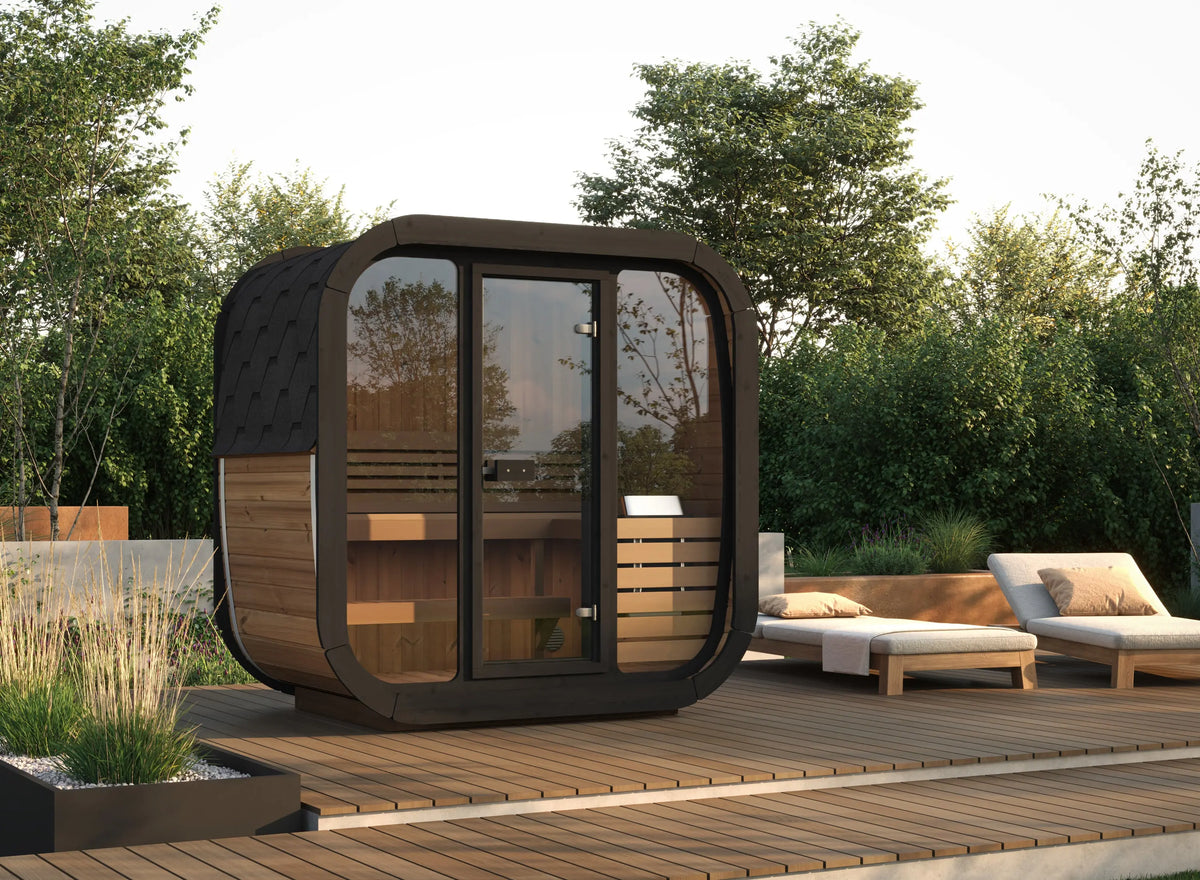 Modern outdoor SaunaLife Cube Sauna CL4G with glass walls on a wooden deck surrounded by greenery
